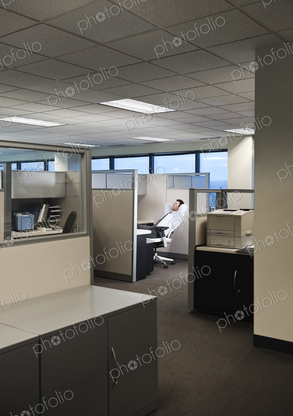 Businessman working in cubicle office.