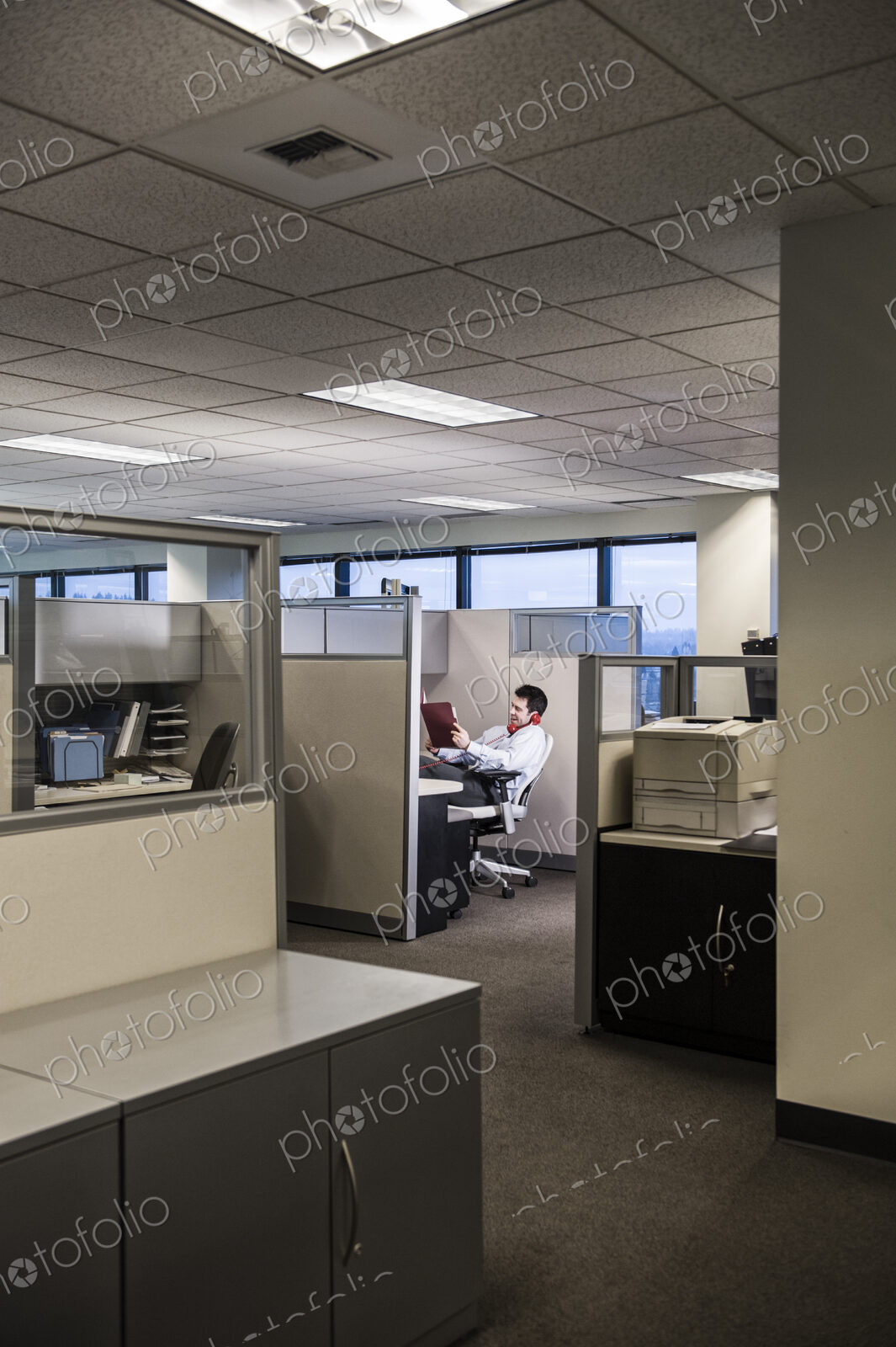 Businessman working in cubicle office.