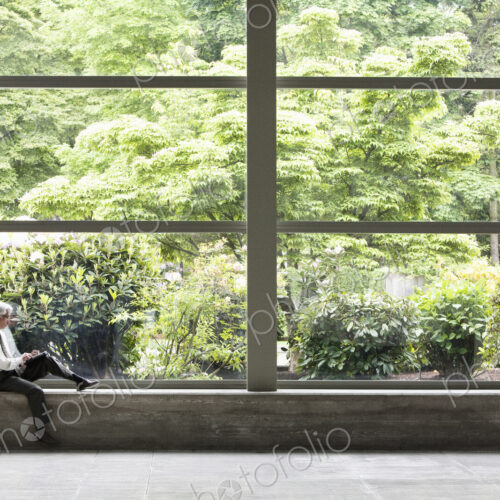 Businessman working on a notebook computer in front of a large window in a convention… Businessman working on a notebook computer in front of a large window in a convention…