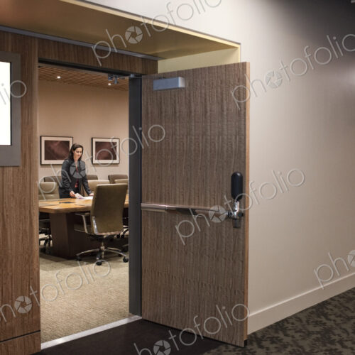 Businesswoman in a large conference room setting. Businesswoman in a large conference room setting.