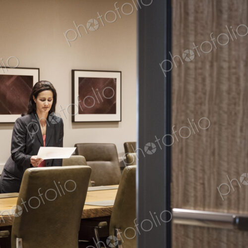 Businesswoman in a large conference room setting. Businesswoman in a large conference room setting.