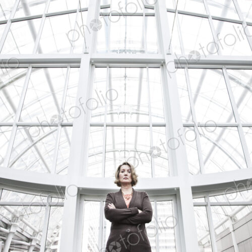 Businesswoman in an atrium with glass roof Businesswoman in an atrium with glass roof