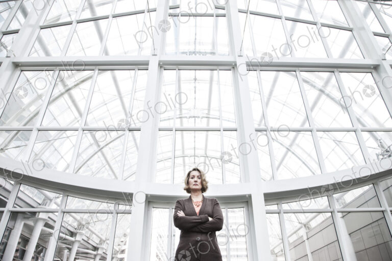 Businesswoman in an atrium with glass roof