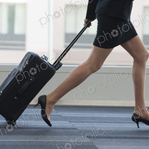 Businesswoman running through the lobby of conference centre. Businesswoman running through the lobby of conference centre.