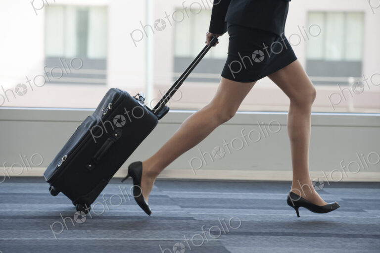 Businesswoman running through the lobby of conference centre.