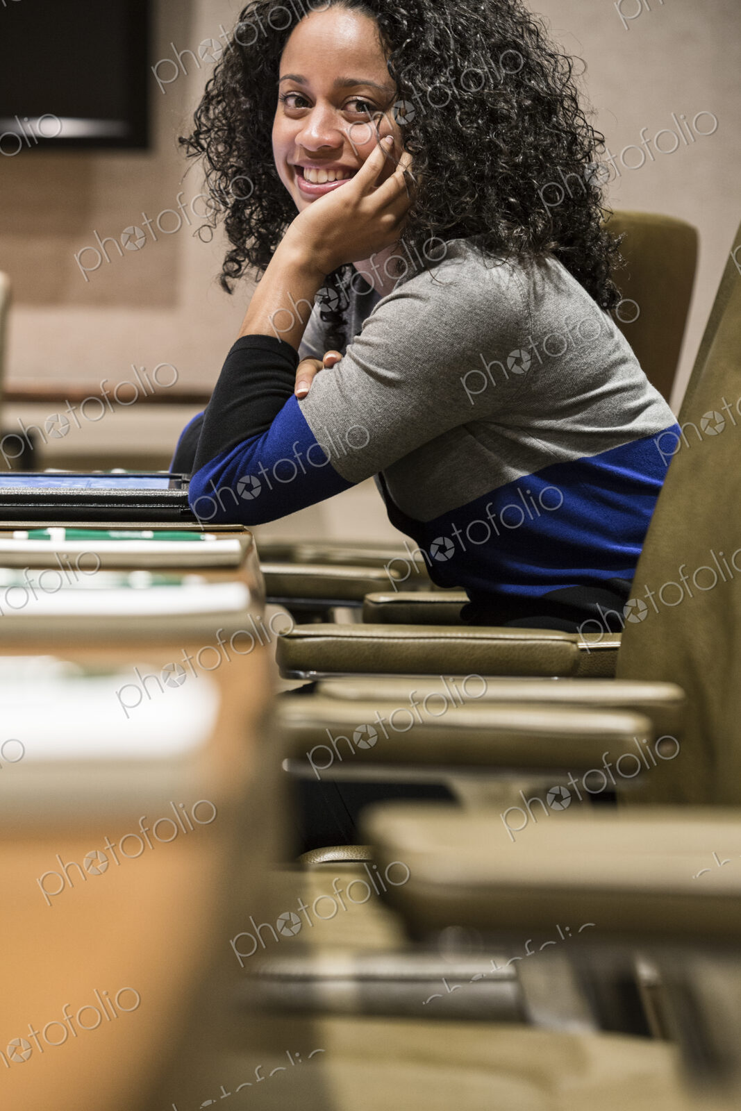 Businesswoman sitting at a conference table turning her head