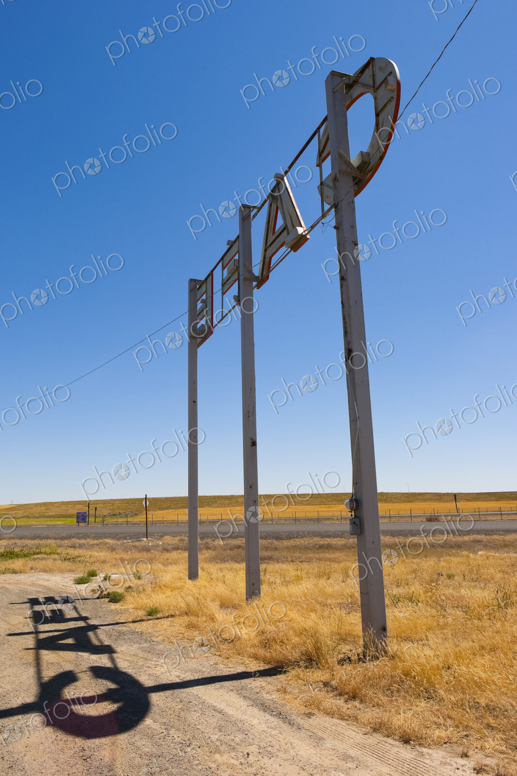 Cafe Sign by the roadside in a desert landscape.