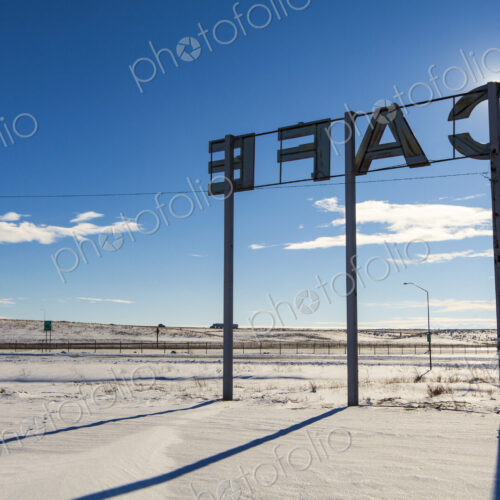 Cafe sign, red letters on posts beside the road, Ritzville.