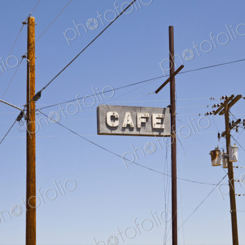 Cafe sign surrounded by power and telephone cables, Wikieup, Arizona, USA.