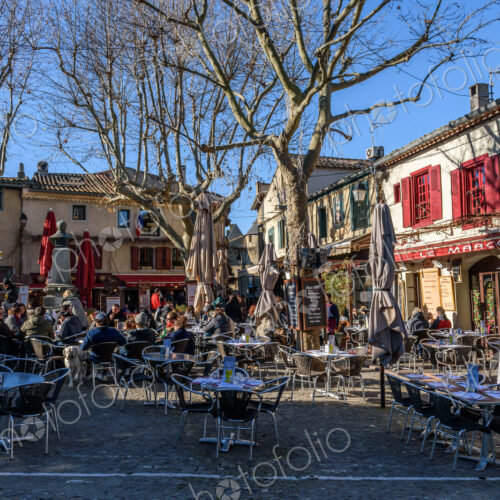 Cafe tables and chairs in a small square in Carcassonne lined with cafes. Cafe tables and chairs in a small square in Carcassonne lined with cafes.