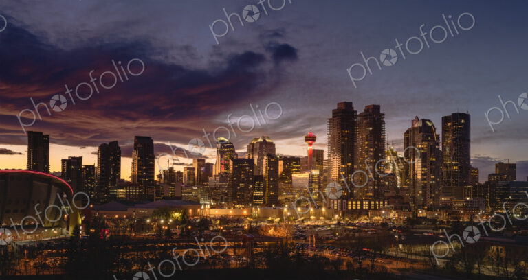 Calgary cityscape lit up at sunset.