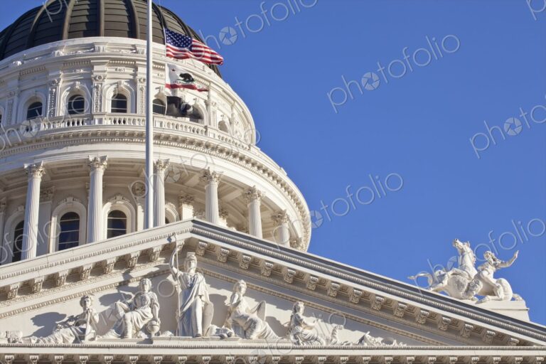 California State Capitol Building with American and California flags, Sacramento.