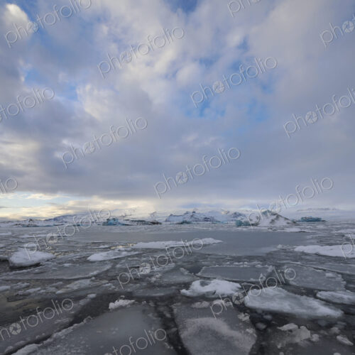 Calved Ice blocks and floes in the Jökulsárlón Glacier Lagoon created by water from…