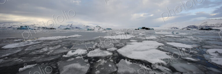 Calved Ice blocks and floes in the Jökulsárlón Glacier Lagoon created by water from…