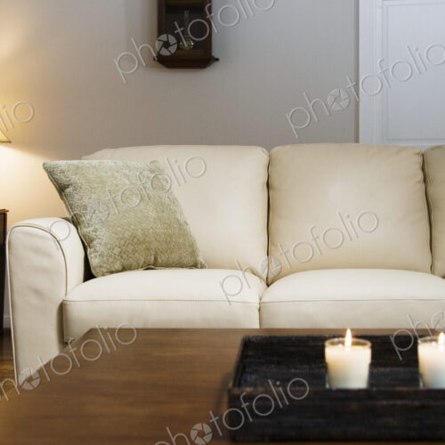 Candles lit on tray in living room