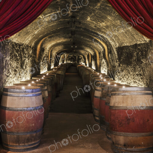 Candles on wine barrels in cave cellar Candles on wine barrels in cave cellar