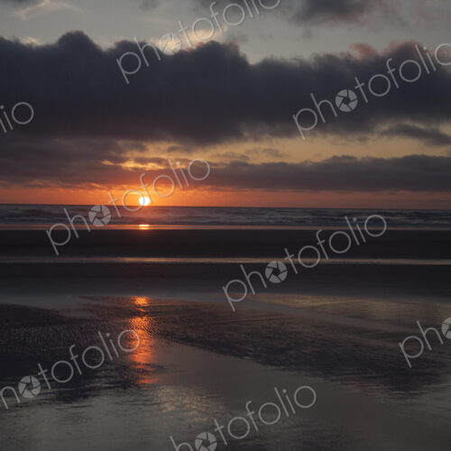 Cannon Beach with dramatic cloudy sky at sunset. Cannon Beach with dramatic cloudy sky at sunset.