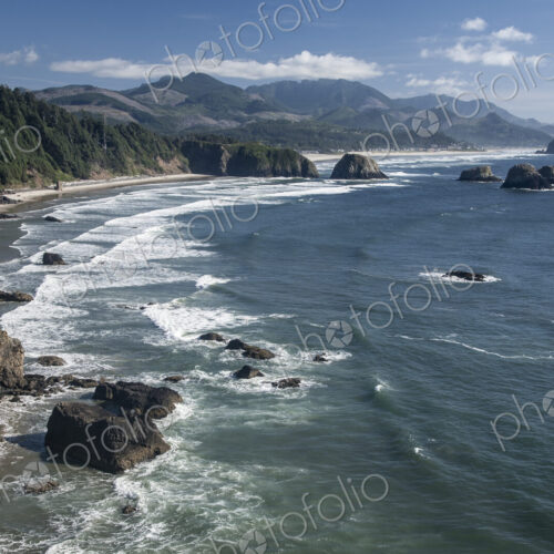 Cannon Beach with waves breaking on rocky shoreline from above. Cannon Beach with waves breaking on rocky shoreline from above.