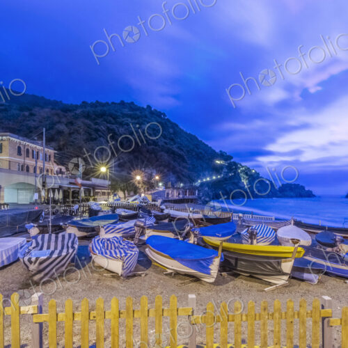 Canoes docked on beach under Monterosso al Mare cityscape, La Spezia, Italy Canoes docked on beach under Monterosso al Mare cityscape, La Spezia, Italy