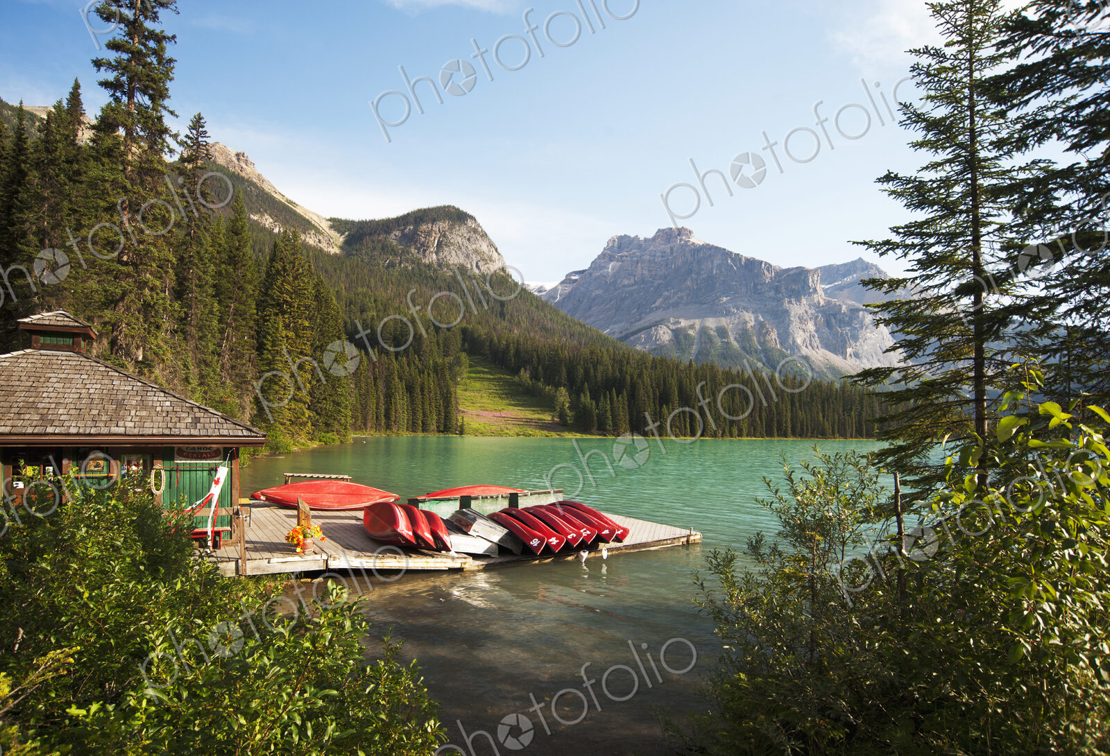 Canoes on wooden dock in rural lake