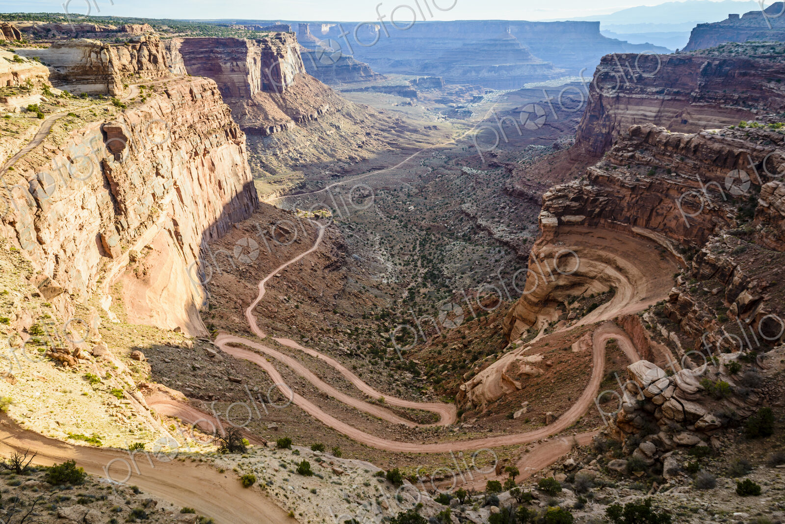 Canyonlands National Park, the view of a zigzag path from the canyon floor up the…