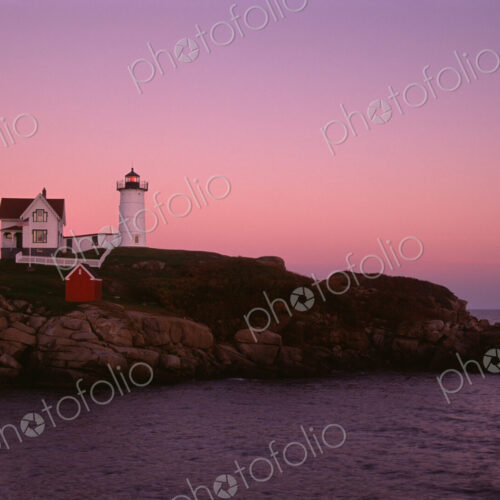 Cape Neddick and the Nubble Lighthouse, on a headland on the Maine coastline at sunset. Cape Neddick and the Nubble Lighthouse, on a headland on the Maine coastline at sunset.