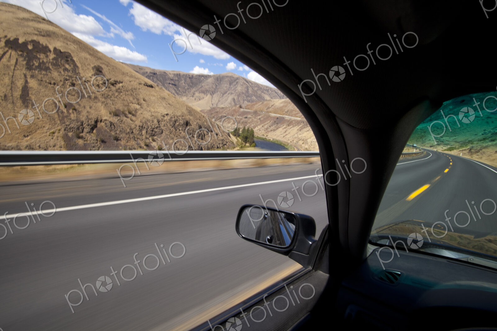 Car driving on road through Yakima River Canyon, Washington, United States