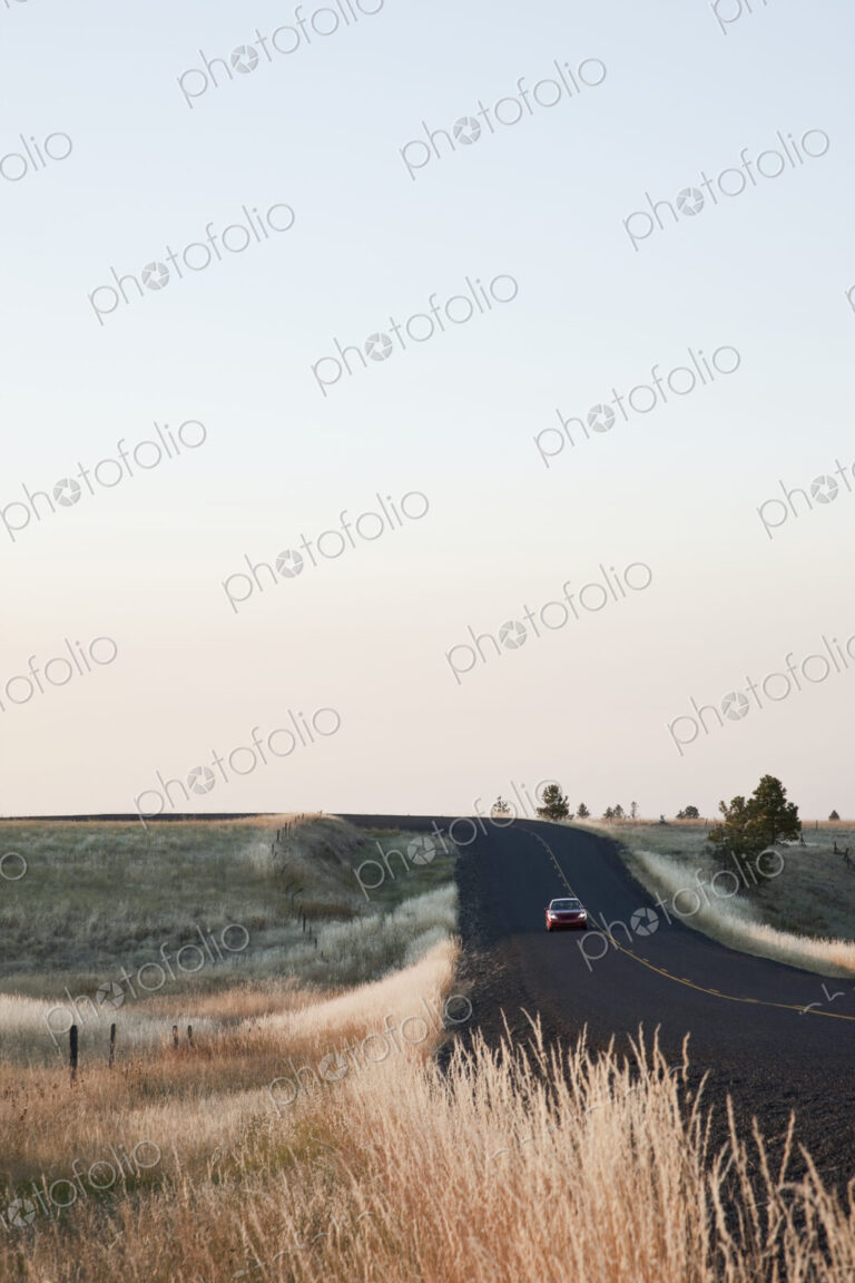 Car driving on rural highway.