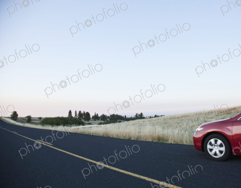 Car driving on rural highway.
