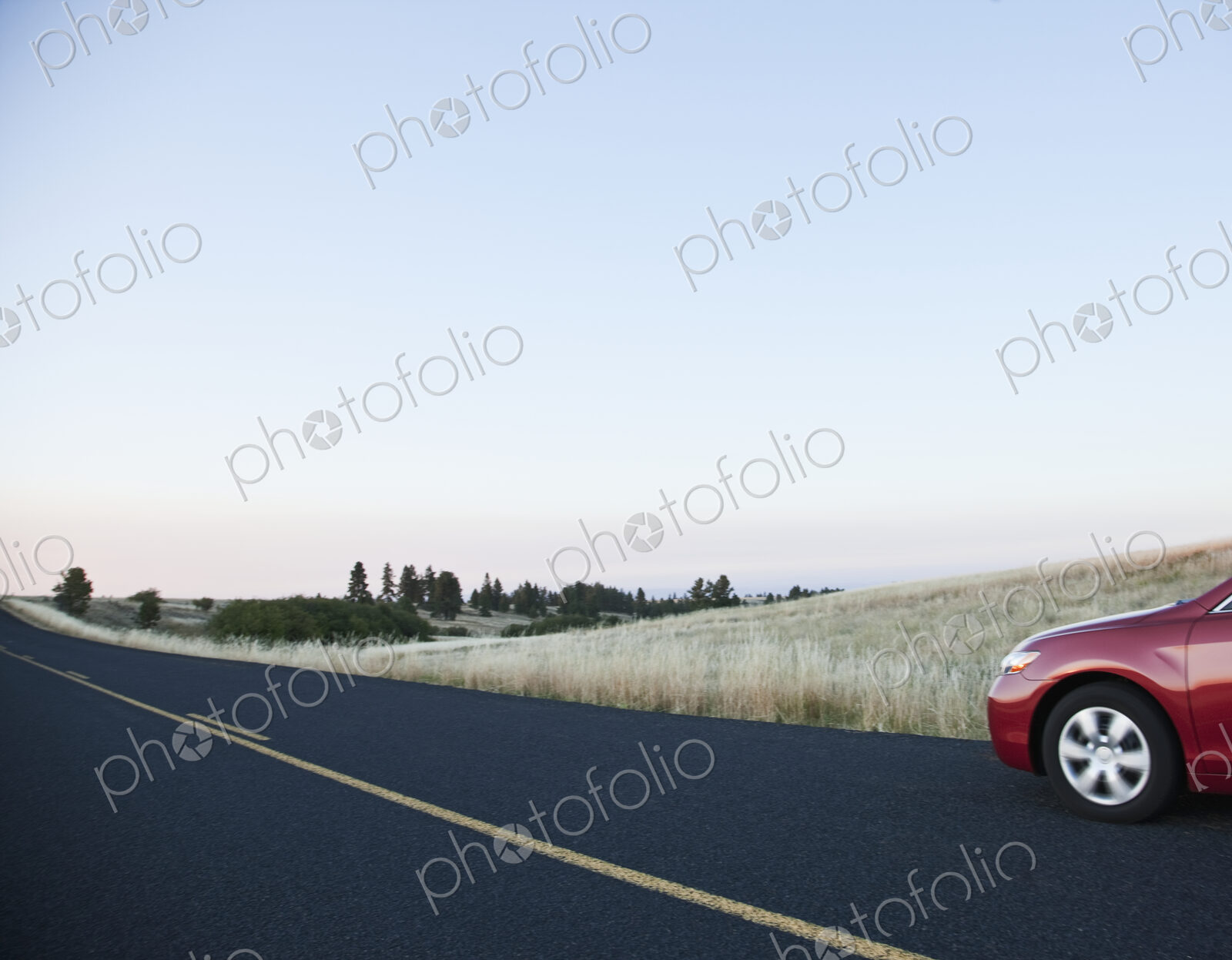 Car driving on rural highway.