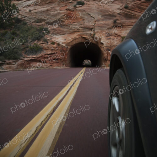 Car driving on rural road in Zion National Park, Utah, United States