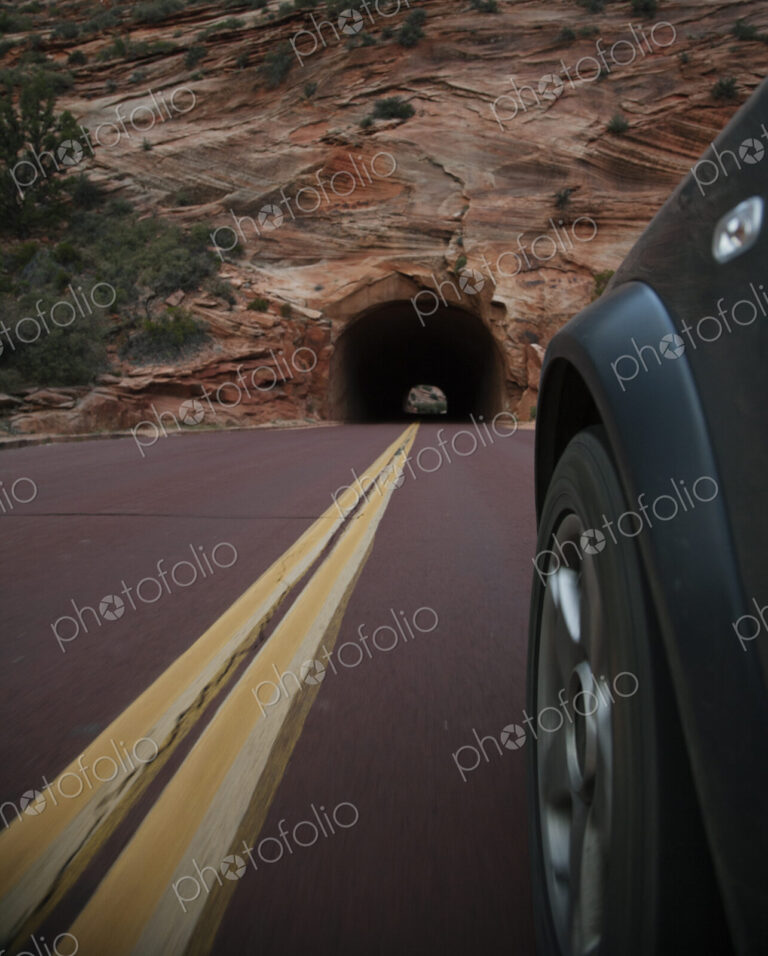 Car driving on rural road in Zion National Park, Utah, United States