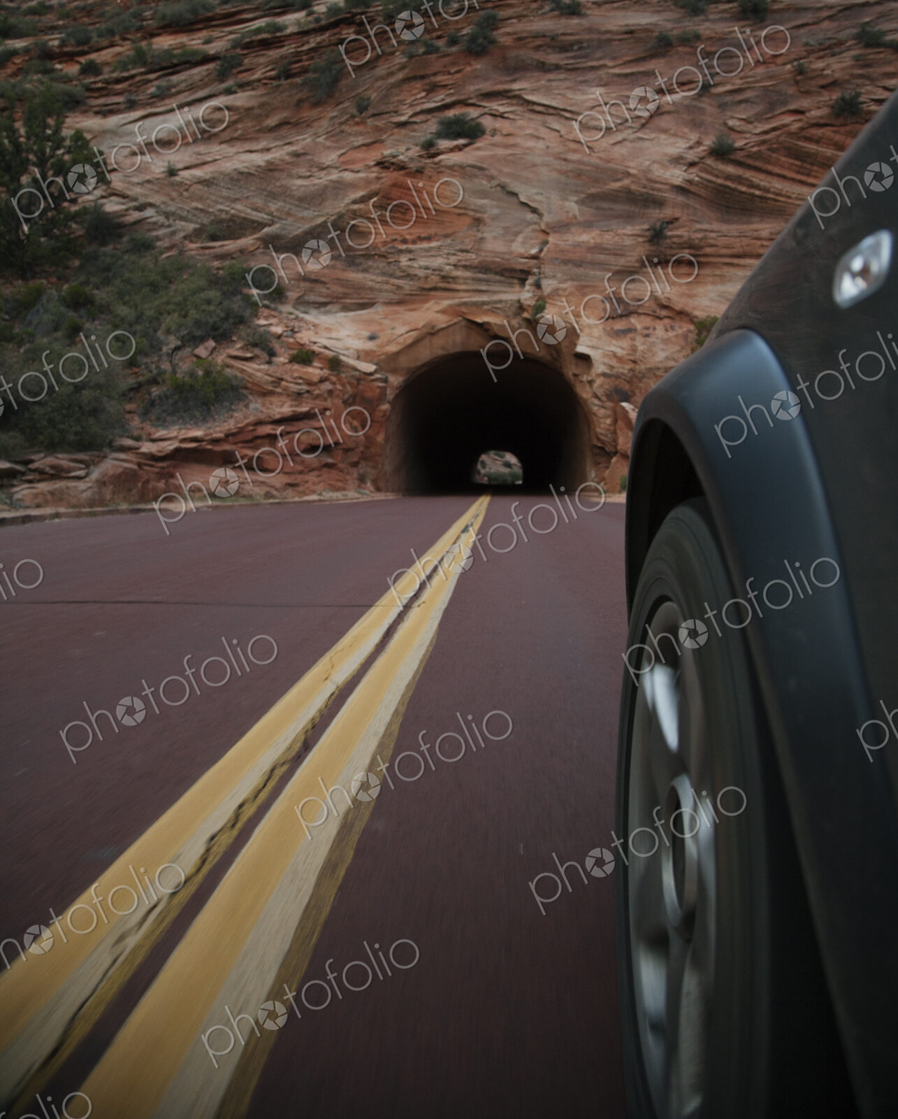 Car driving on rural road in Zion National Park, Utah, United States