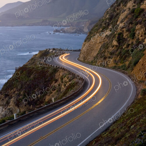 Car headlights on California Highway 1 south of the town of Carmel on the Big Sur… Car headlights on California Highway 1 south of the town of Carmel on the Big Sur…