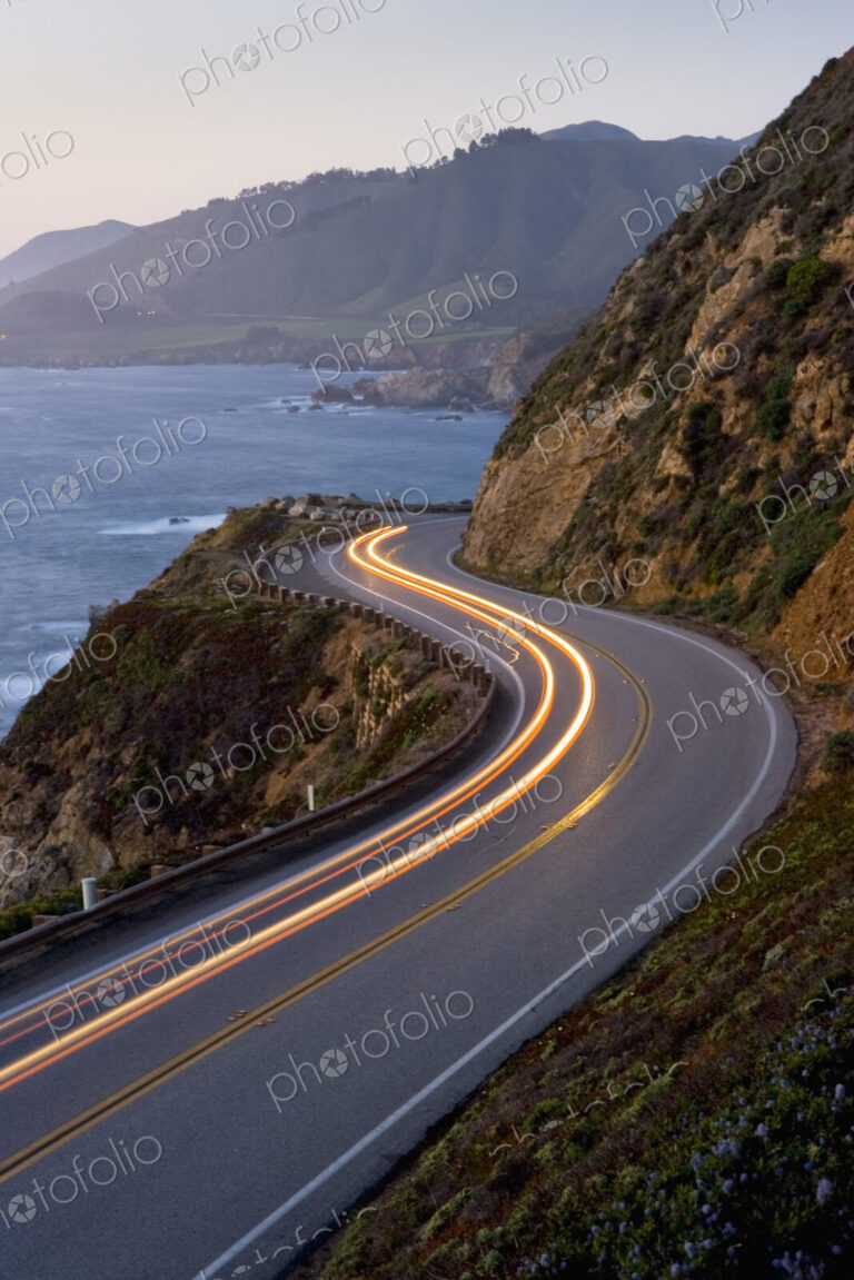 Car headlights on California Highway 1 south of the town of Carmel on the Big Sur…