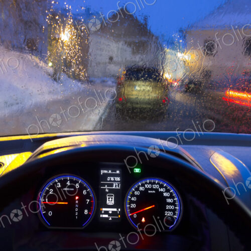Car interior and illuminated street view. Dashboard, speedometer Car interior and illuminated street view. Dashboard, speedometer