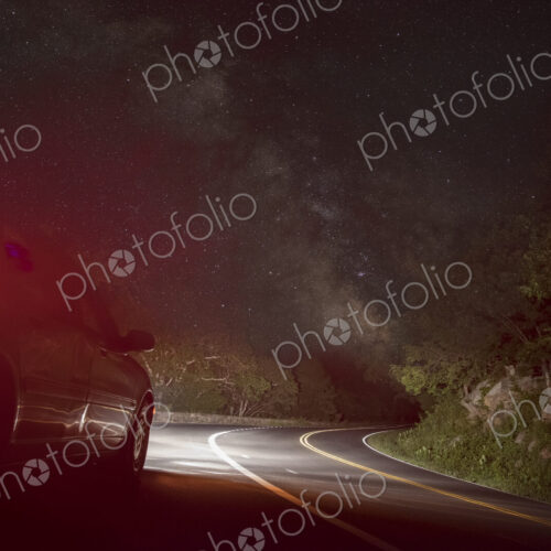 Car on winding road under starry sky Car on winding road under starry sky