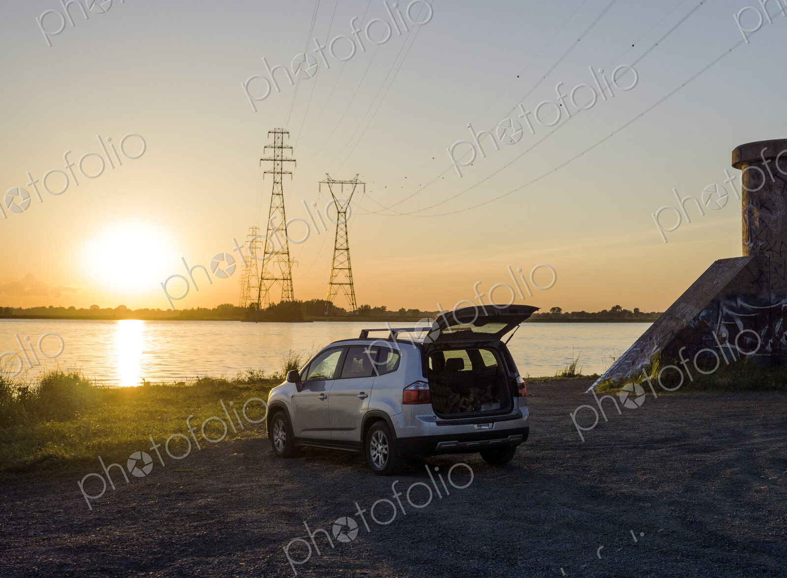 Car parked on rural lake shore