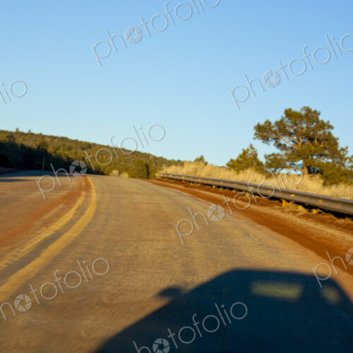 Car shadow on a two lane highway, New Mexico.