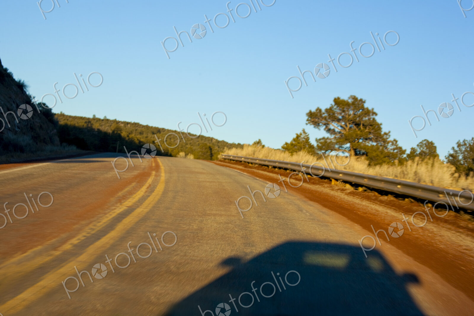 Car shadow on a two lane highway, New Mexico.