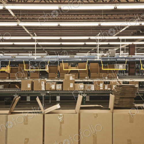 Cardboard boxes along production line in warehouse Cardboard boxes along production line in warehouse