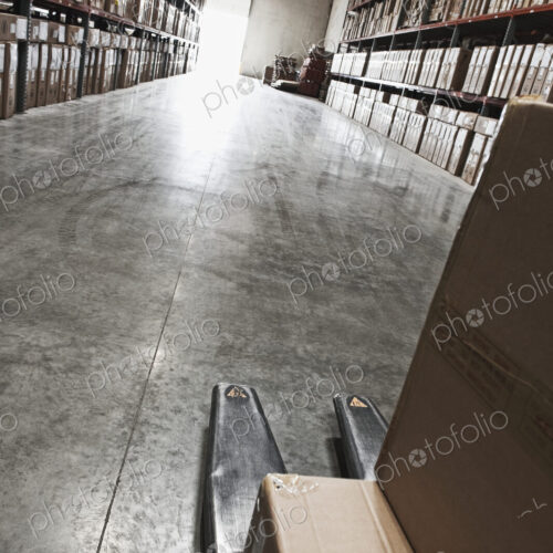 Cardboard boxes on forklift in warehouse Cardboard boxes on forklift in warehouse