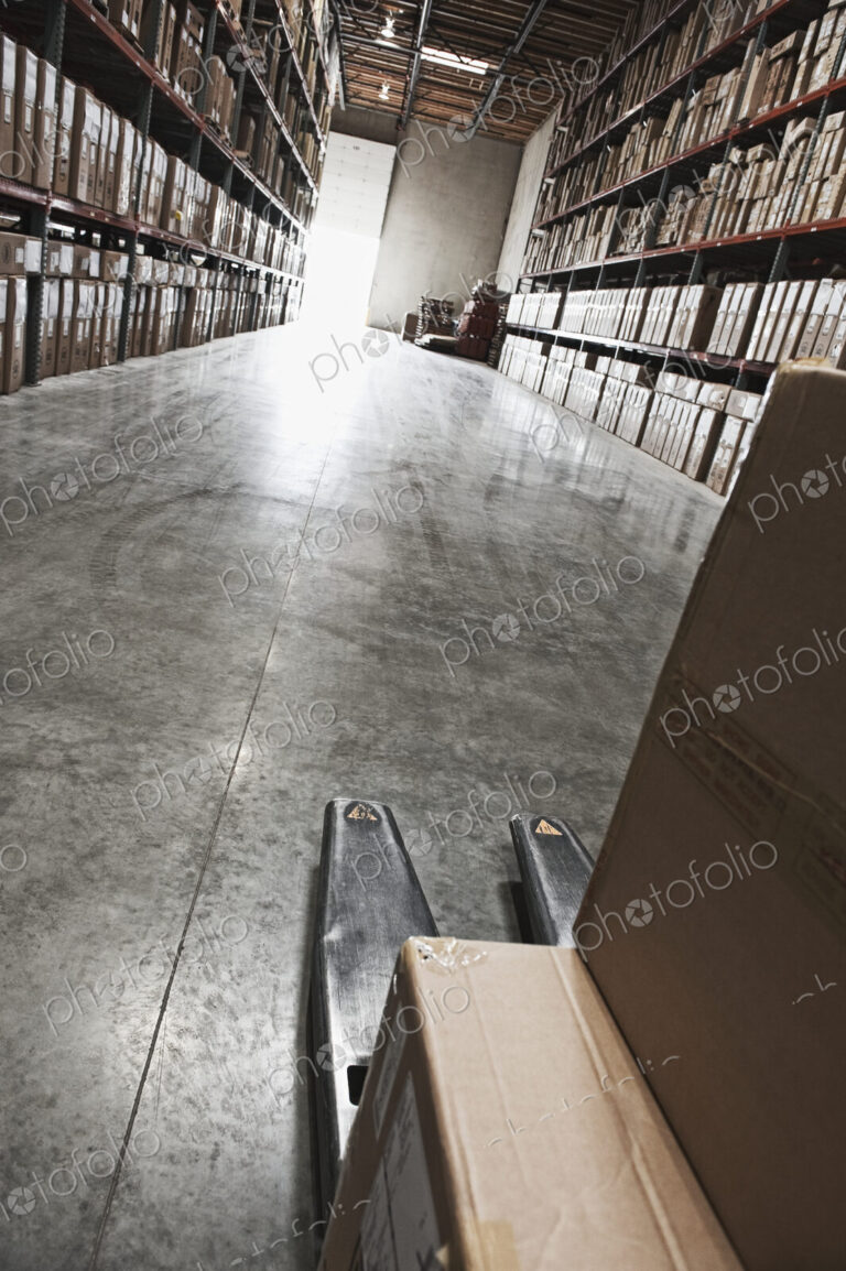 Cardboard boxes on forklift in warehouse