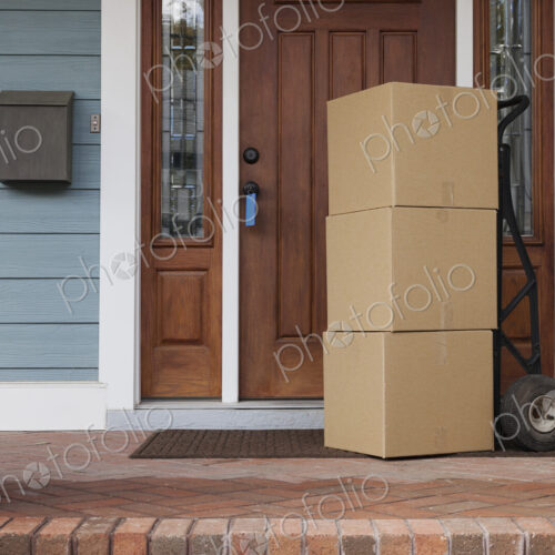 Cardboard boxes on front porch of new house Cardboard boxes on front porch of new house
