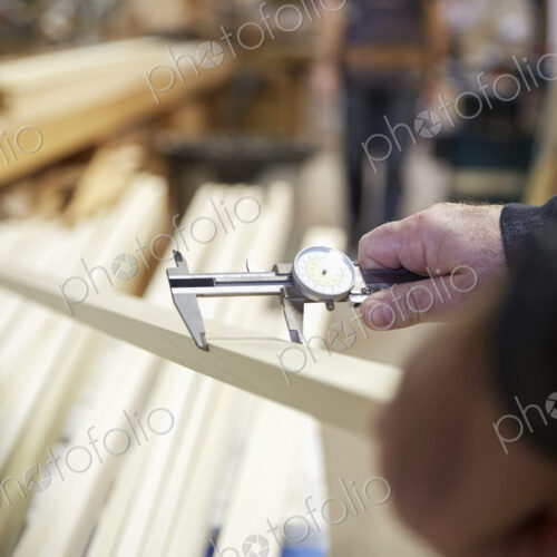 Carpenter measuring wood in workshop Carpenter measuring wood in workshop