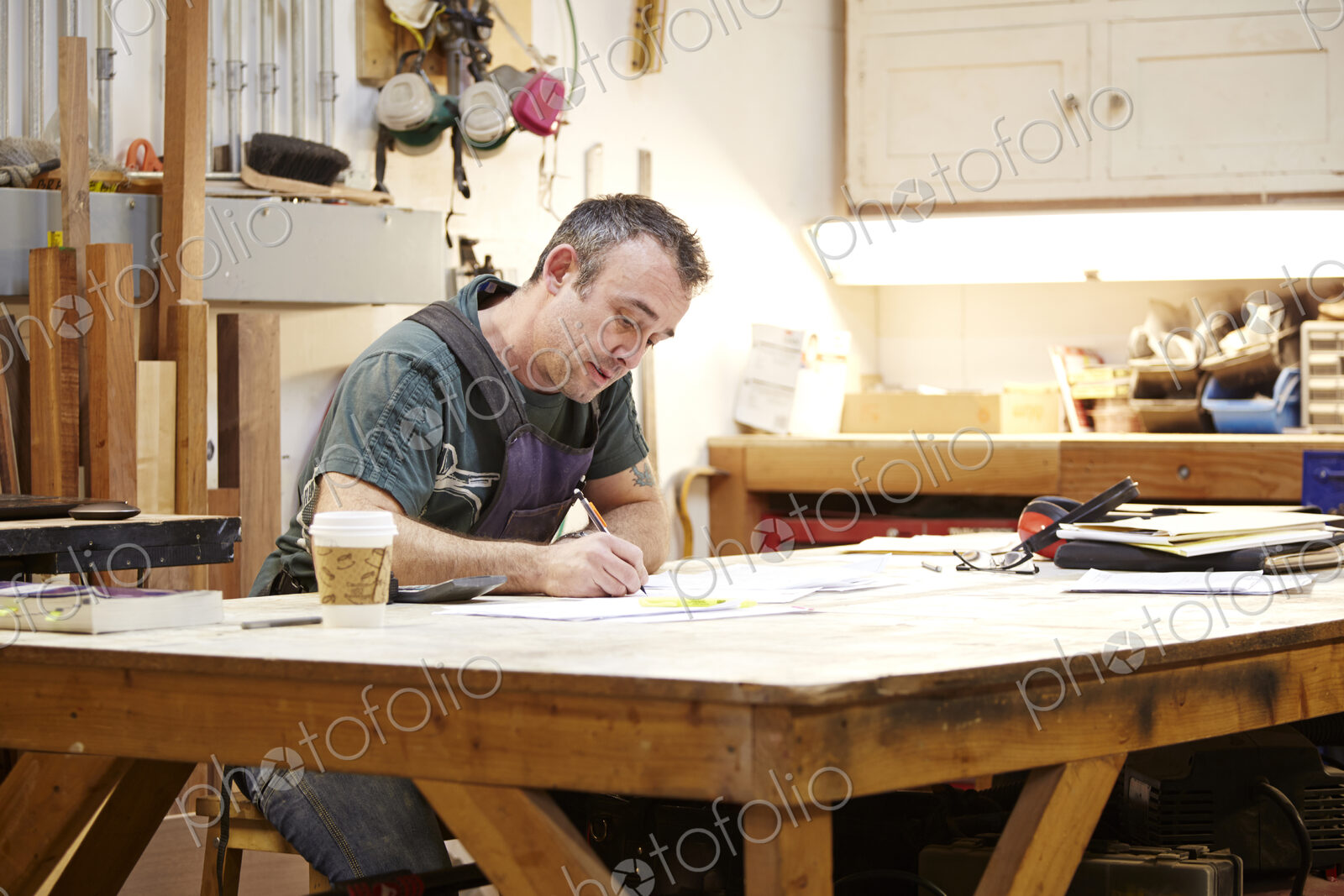 Carpenter sketching in workshop