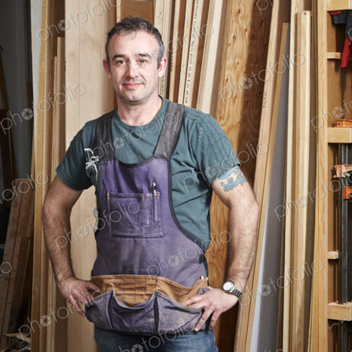 Carpenter smiling in workshop Carpenter smiling in workshop