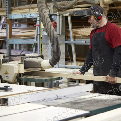 Carpenter using saw in workshop Carpenter using saw in workshop