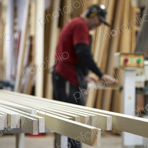 Carpenter using saw in workshop Carpenter using saw in workshop