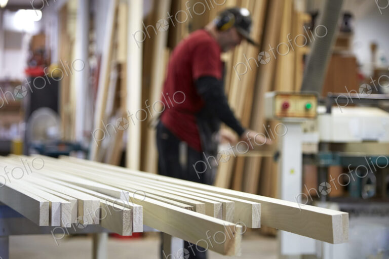 Carpenter using saw in workshop